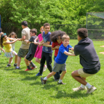 Children play tug-of-war in a summer camp at The College School, housed in UD’s College of Education and Human Development.