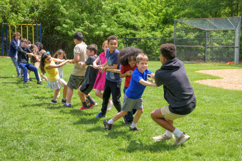Children play tug-of-war in a summer camp at The College School, housed in UD’s College of Education and Human Development.