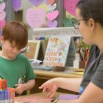 A UD education student guides a child in a writing activity at UD’s Lab School, an early education center for children from the ages of six months through kindergarten.