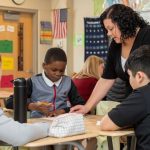 Delaware elementary school students work with their teacher during math class.